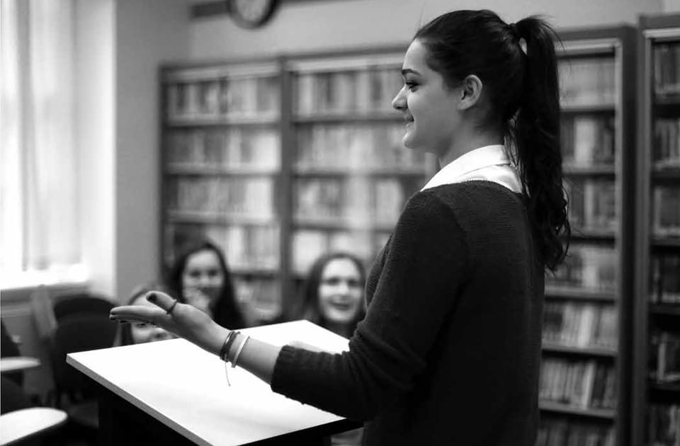 Student speaking at a lectern